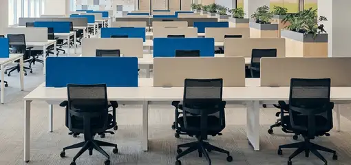 Modern open-plan office space featuring clean workstations, ergonomic chairs, and sanitized carpets provided by professional office cleaning services in Spokane, WA.