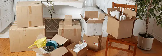 Packed moving boxes and household items in a kitchen before move-out or move-in cleaning, Spokane, WA.